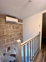 a room with a staircase with a heater on the wall at Élégante &amp; Design Casa Churchill - Brive Centre in Brive-la-Gaillarde