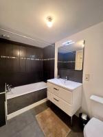 a bathroom with a sink and a tub and a toilet at Élégante &amp; Design Casa Churchill - Brive Centre in Brive-la-Gaillarde