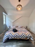 a bedroom with a large bed in a white room at Élégante &amp; Design Casa Churchill - Brive Centre in Brive-la-Gaillarde
