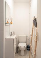 a white bathroom with a toilet and a sink at Casa Lyon Cosy 1 Br Flat Part Dieu in Lyon
