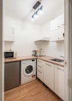 a kitchen with white cabinets and a washing machine at Casa Lyon Cosy 1 Br Flat Part Dieu in Lyon