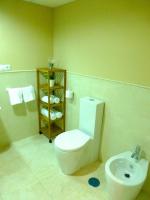 a bathroom with a toilet and a sink at Casa Valdevaqueros in Tarifa