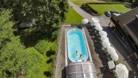 an overhead view of a swimming pool with two people in it at Sweet Cherry - Boutique &amp; Guesthouse Tyrol in Innsbruck