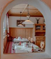 a dining room with two tables and an archway at Sweet Cherry - Boutique &amp; Guesthouse Tyrol in Innsbruck