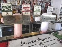 a bar with two pink drinks on a counter at Sundeck Hotel in Perisher Valley