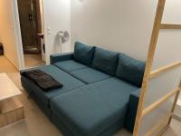 a blue couch sitting in a living room at Charming intim apartment in Paris South in Montrouge
