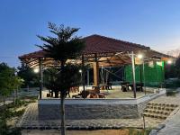 a pavilion with a tree in front of it at Đức Lưu Quang Hotel Bình Thuận in Tuy Phong