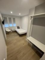 A bed or beds in a room at Habitaciones Arrisal