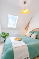 a bedroom with a bed with a tray of food on it at Le Cocon Forestier - Proche aéroport Beauvais, Chantilly, forêt de Hez-Froidmont, parking public gratuit, Wifi &amp; Netflix in Clermont