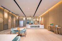 a lobby with tables and chairs and a counter at EVEN Hotels Shanghai Expo by IHG in Shanghai