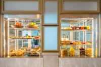 a bakery with a display case filled with lots of food at EVEN Hotels Shanghai Expo by IHG in Shanghai