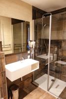a bathroom with a sink and a shower at Camping Bissen in Esch-sur-Sûre