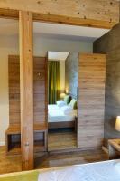 a bedroom with a bed and a large mirror at Camping Bissen in Esch-sur-Sûre