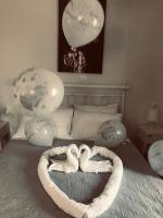 a bed with two heart shaped balloons on it at tonias studio in Kanálion