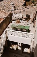 an overhead view of a patio with a table on a roof at Maison Arthur in Aigues-Mortes