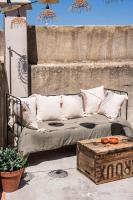 a couch sitting on a patio with a table at Maison Arthur in Aigues-Mortes