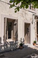 a building with two windows and a door at Maison Arthur in Aigues-Mortes