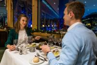 a man and a woman sitting at a table eating food at Hotel Vier Jahreszeiten am Schluchsee in Schluchsee