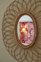 a mirror with a lamp in a room at Hôtel du Danube Saint Germain in Paris