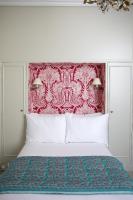 a bedroom with a large bed with a red headboard at Hôtel du Danube Saint Germain in Paris