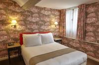 a bedroom with a bed with red floral wallpaper at Hôtel du Danube Saint Germain in Paris