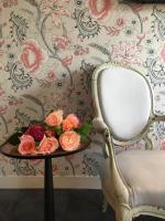 a table with a plate of flowers and a chair at Hôtel du Danube Saint Germain in Paris