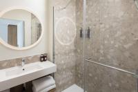 a bathroom with a shower and a sink and a mirror at Residence Inn by Marriott Paris Didot Montparnasse in Paris