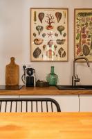 a kitchen with a sink and a counter top with a picture at Maison Arthur in Aigues-Mortes