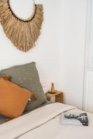 a bedroom with a bed with a pillow and a mirror at Maison Arthur in Aigues-Mortes