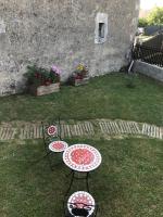 two tables and chairs in the grass in a yard at Lou Bohème in Le Briou