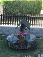 a statue of a flower pot on a rock with flowers at Lou Bohème in Le Briou