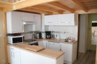 a kitchen with white cabinets and a counter top at Bel appt 3 * plein Centre ville 4 pers. + balcon in Cauterets