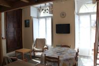 a living room with a table and a tv on the wall at Bel appt 3 * plein Centre ville 4 pers. + balcon in Cauterets