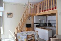 a kitchen with a staircase and a table and a kitchen with a table at Bel appt 3 * plein Centre ville 4 pers. + balcon in Cauterets