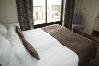 a bed in a room with a large window at La Vieille Auberge in Le Mont Saint Michel