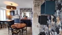 a kitchen and a dining room with a table at le panoramique in Quimper