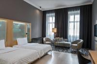 a hotel room with two beds and a living room at Le Méridien Vienna in Vienna