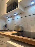 a kitchen with a toaster sitting on a counter at Appartement neuf entièrement équipé proche centre in Amiens