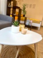 a white coffee table with a plant on top of it at Appartement neuf entièrement équipé proche centre in Amiens