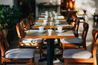 a row of wooden tables and chairs in a restaurant at Hotel Nya in Montezuma