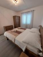 a bedroom with two beds and a window at Family Room Drace 4550a in Drače