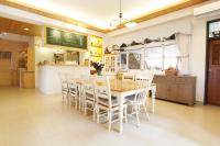 a dining room with a table and chairs at Bear Meets Moose Homestay B&amp;B in Puli