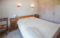 a small bedroom with a bed and a chair at Nice Home In Taulignan With Wifi in Taulignan