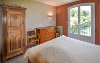 a bedroom with a bed and a dresser and a window at Nice Home In Taulignan With Wifi in Taulignan
