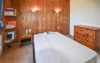a bedroom with a large bed and a wooden wall at Nice Home In Taulignan With Wifi in Taulignan