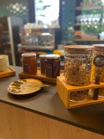 a counter with jars of food and spoons at Hôtel Restaurant BO &amp; MIA in La Baule