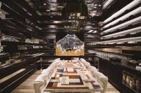 a long dining room with a long table and white chairs at W Bellevue in Bellevue