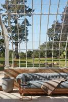 a living room with a couch and a large window at DOMAINE LE MEZO in Ploeren