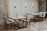 a group of tables and chairs in a room at Hotel Toscania in Włoszakowice