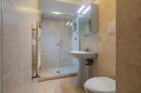 a bathroom with a shower and a toilet and a sink at Hotel Casa Boccassini in Venice